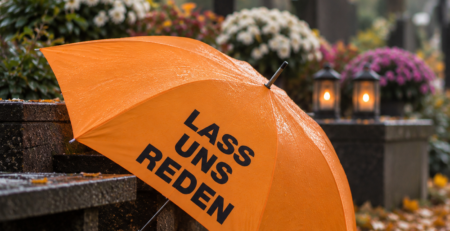 Orangefarbener Schirm der Aktion „Lass uns reden“ auf einem Friedhof (KI-generiertes Bild)